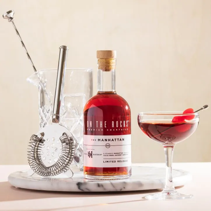 A bottle of On the Rocks Manhattan and a cocktail set
