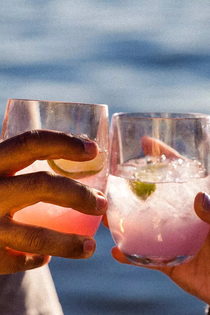 people drinking on the rocks cocktails in the sunset