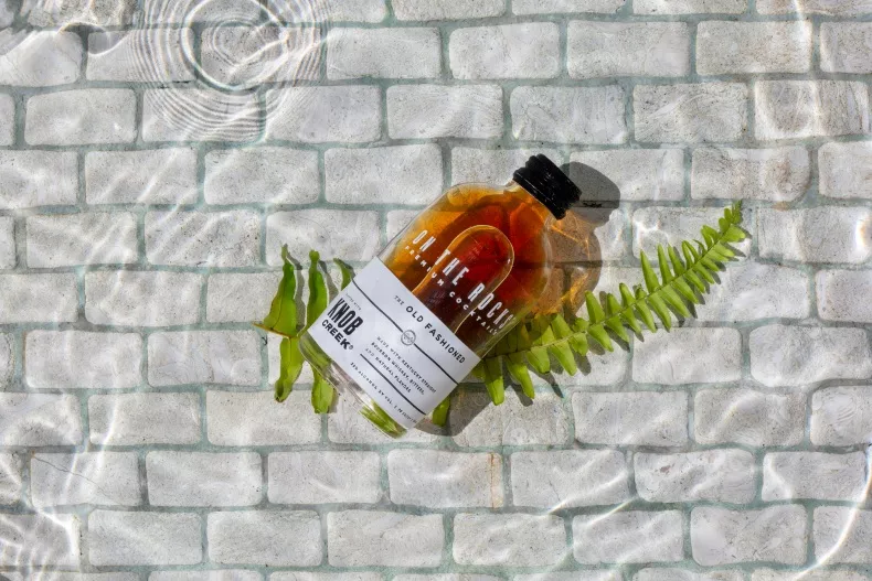 Knob Kreek bottle laid on star hill with provisions mural