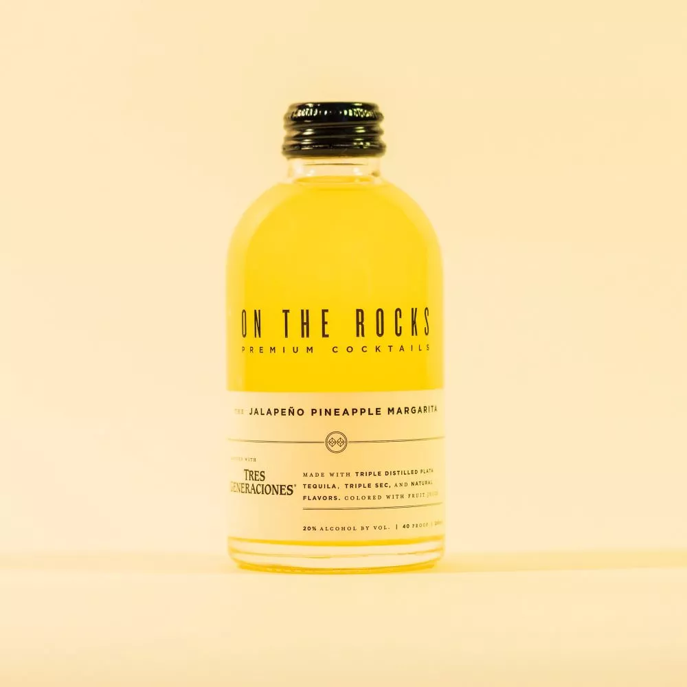 OTR Jalapeno pineapple margarita cocktail bottle in yellow lighting