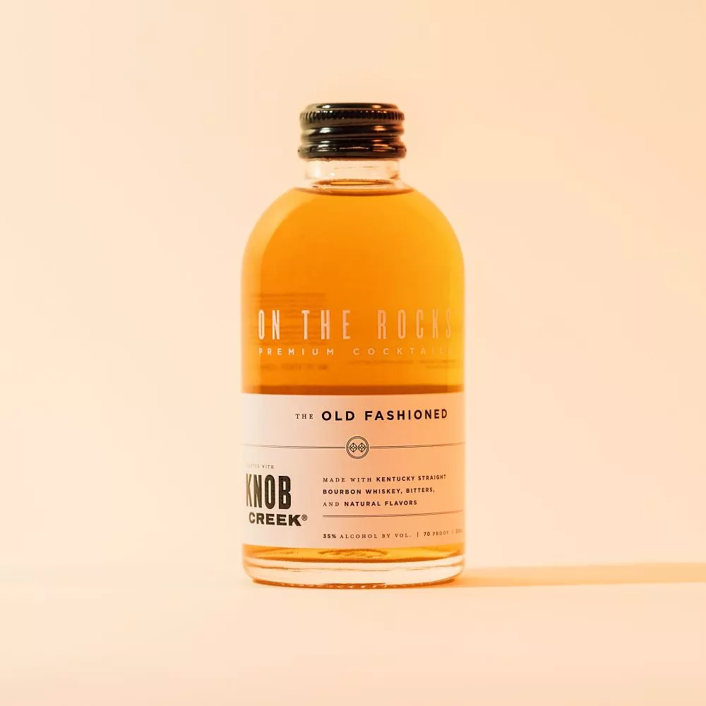 OTR Old fashioned cocktail bottle in light brown lighting 