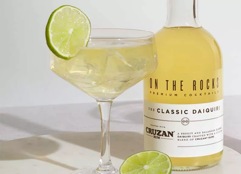 A glass and a bottle of OTR Daiquiri cocktail