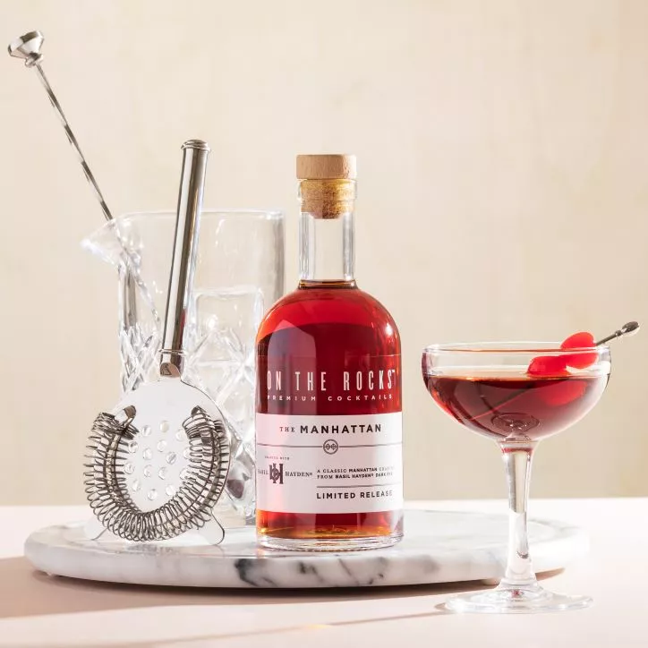 A bottle of On the Rocks Manhattan and a cocktail set