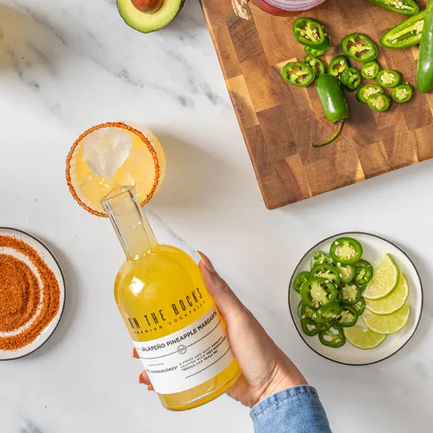 a person is pouring drink in glass