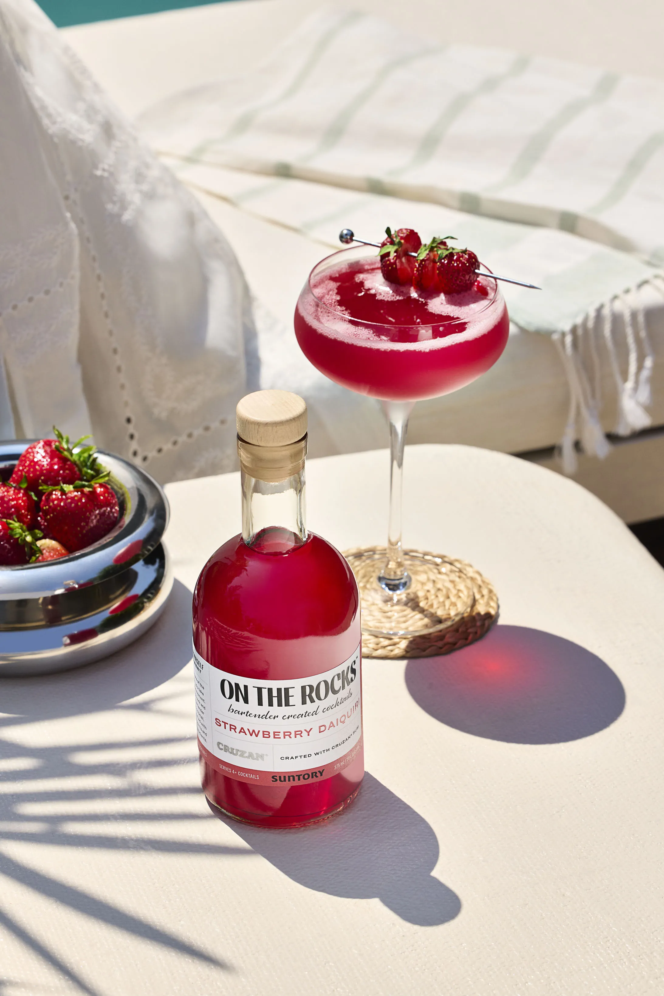 A glass of strawberry Daiquiri garnished with strawberries